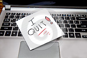 Laptop with sign laying on it, I quit!