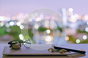 Laptop, smartphone and earphone are turning off put on table