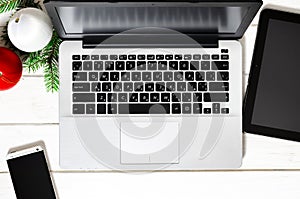 Laptop, smartphone and tablet on a white wooden table. Online shopping