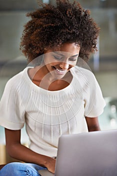 Laptop, smile and adult education with black woman in living room of home for education, learning or study. Computer