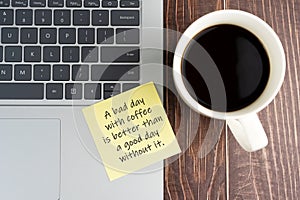 Laptop and sticky note of coffee mug with text - A bad day with coffee is better than a good day without it