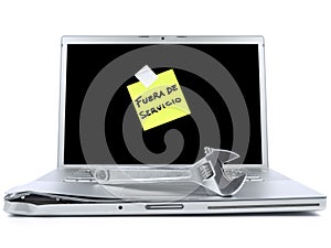 Laptop with sticky note and tool