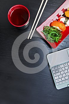 Laptop with sushi sashimi set with copy space