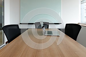 Laptop on table in corporate conference room
