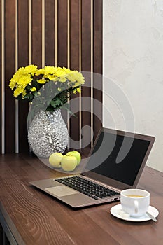 Laptop on table in kitchen interior