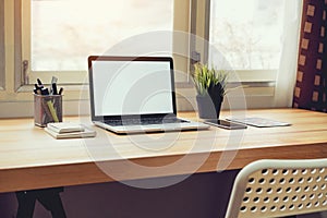 Laptop on table in office room background, for graphics display montage.