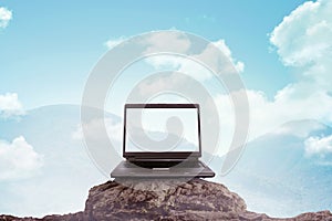 Laptop on the top of the mountain