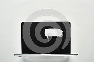 Laptop with white blank speech bubble on white background, cyberbullying concept.