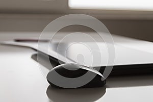 Laptop with white screen mock up template. Office desk with computer; coffee cup and pen