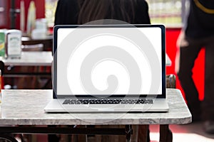 Laptop with white screen on a table in a coffee house