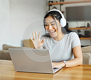 laptop woman computer headphone technology call video communication online internet happy asian