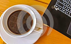 Laptop work at table with coffee cup in Mexico