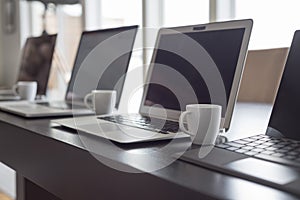 Laptops and espresso lined up photo