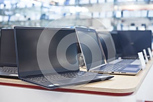 Laptops on the table in the electronics store photo