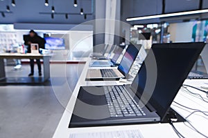 Laptops on the table in the electronics store. The department of laptops in the tech store. Buy a laptop