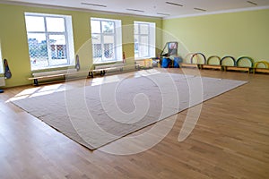 Lardge empty elementary school or kindergarten modern gym room with sport and recreational equipment