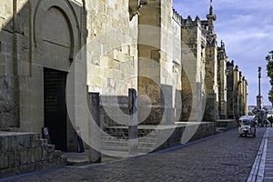 Lareral of the Mosque of Cordoba with the statue of San Rafael at the end of the street