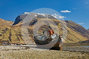 Large abandoned shipwreck on the shore of Loch Linnhe in Scotland in the afternoon