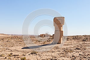 Large abstract figure carved from stone in a public sculpture park in the desert, on a cliff above the Judean Desert near Mitzpe
