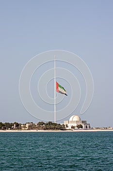 Large Abu Dhabi flag flying at half-mast