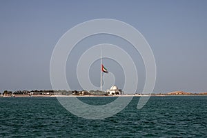 Large Abu Dhabi flag flying at half-mast