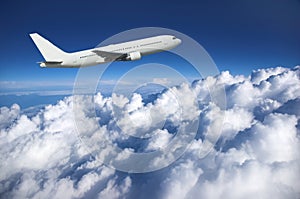 Large airliner along clouds