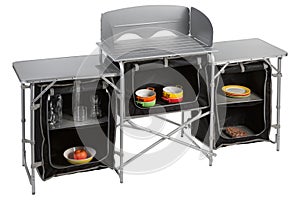 Large aluminum folding camping table, consisting of three sections, with a set of utensils, on a white background