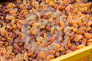 A large amount of yellow-brown raisins, texture