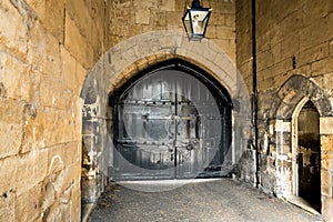 Large ancient black wooden doors in the Tower of London