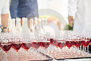 A large array of wine glasses await thristy guests at an outdoor