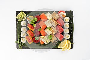 Large assortment of assorted sushi maki made from salmon, tuna, shrimp roe of tobiko flying fish, rice and sesame seeds
