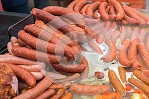 Large assortment of fried and grilled sausages and hamburgers