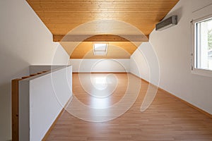 Large attic with wooden floors and exposed beams