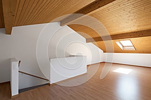 Large attic with wooden floors and exposed beams