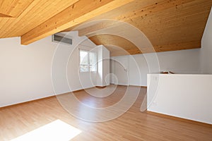 Large attic with wooden floors and exposed beams