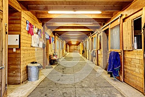 Large and authentic horse barn with many stalls. photo