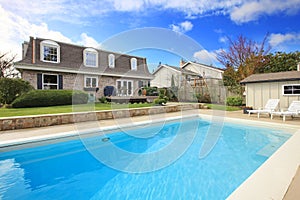 Large backyard with flowerbed and swimming pool