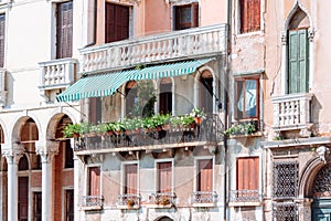 Large balcony with many flower pots on it. Venice, Italy