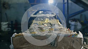 Large bales of pressed trash out of paper and plastic bottles at a recycling plant, industry, inside