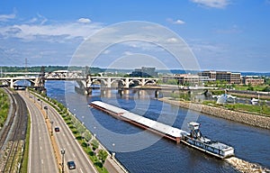 A large barge passes through the Robert Street Lift Bridge.