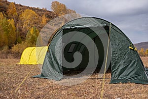 Large basecamp tents on colorful mountains background