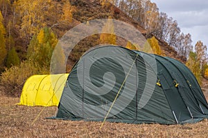 Large basecamp tents on colorful mountains background