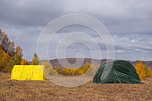 Large basecamp tents on colorful mountains background