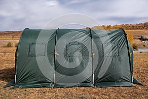 Large basecamp tents on colorful mountains background