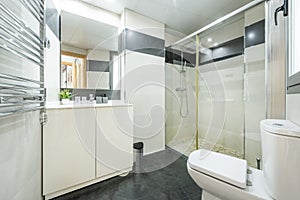 Large bathroom with mirror and shower with screen in vacation