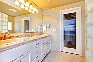 Large bathroom with white cabinets