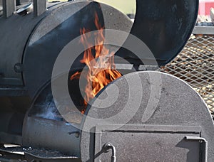 Large BBQ smoker with flames