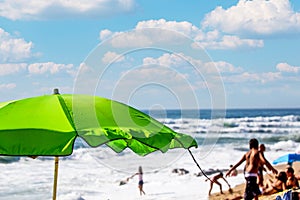 Large beach parasol in the beach with a calm view to the Atlantic ocean.