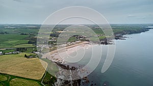 large beach with rock formations from a cliff. Bunmahon Beach. Cooper Coast, Waterford, Ireland