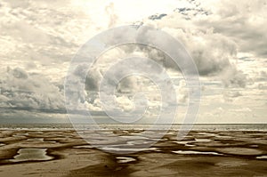 large beach with sormy clouds